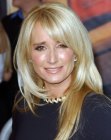 Kim Richards wearing a long hairstyle with heavy bangs and lots of shine