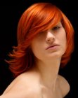 Red hair in a medium length circle cut with razoring