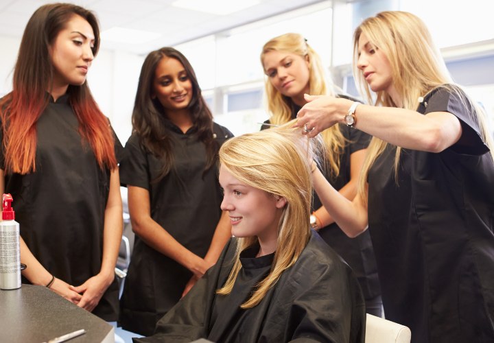 Hair school students learning how to cut ans style hair