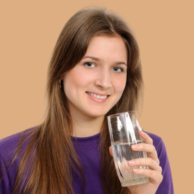 Woman who is drinking water for healthy hair
